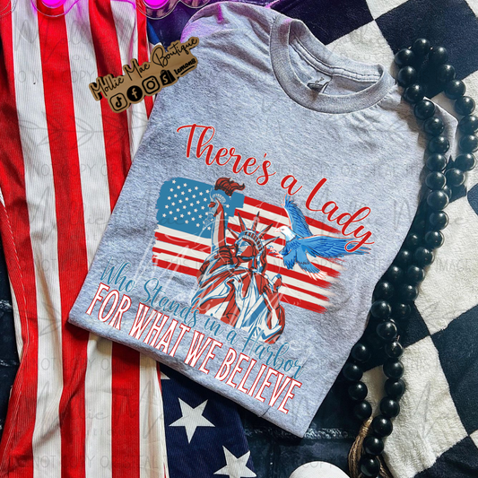 There's A Lady Who Stands In A Harbor For What We Believe Tshirt