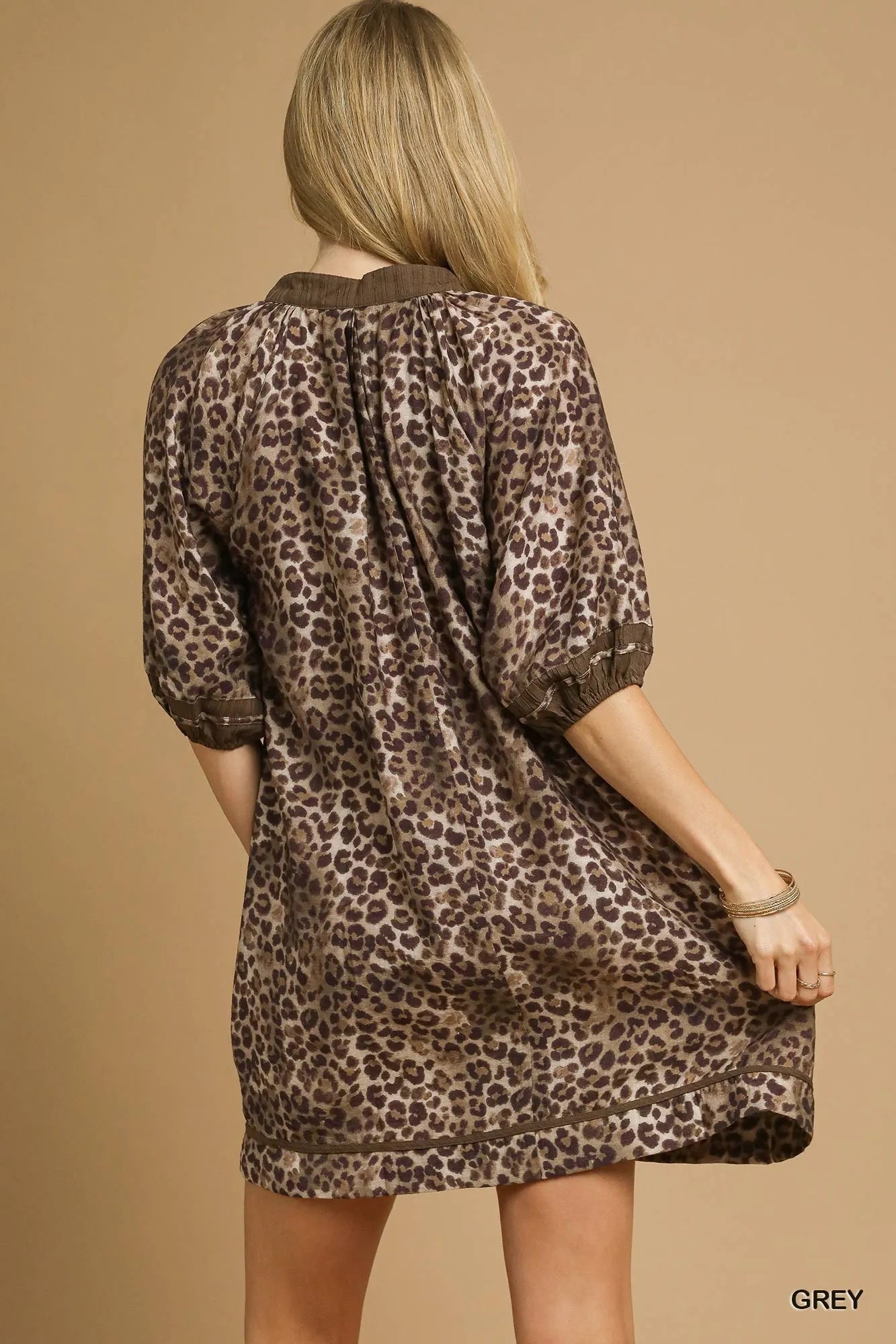 A woman wearing a leopard print dress.