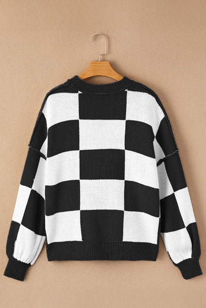 Black checkered exposed seam drop shoulder sweater with checkered knit, exposed seam details and relaxed drop shoulders, women’s boutique fashion