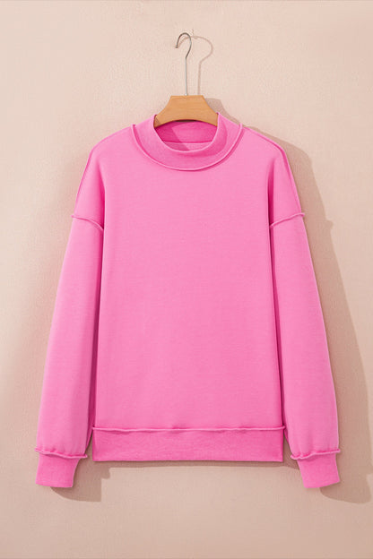 Bright pink plus size reversible mock neck sweatshirt with exposed seams and relaxed drop shoulders, boutique casual top