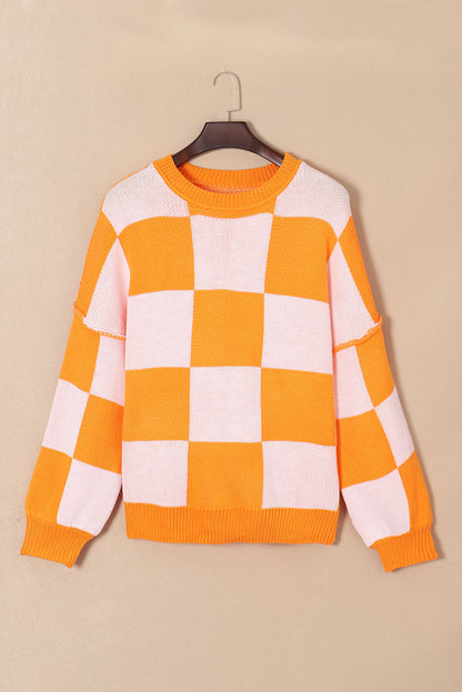 Grapefruit Orange checkered exposed seam drop shoulder sweater with checkered knit, exposed seam details and relaxed drop shoulders, women’s boutique fashion
