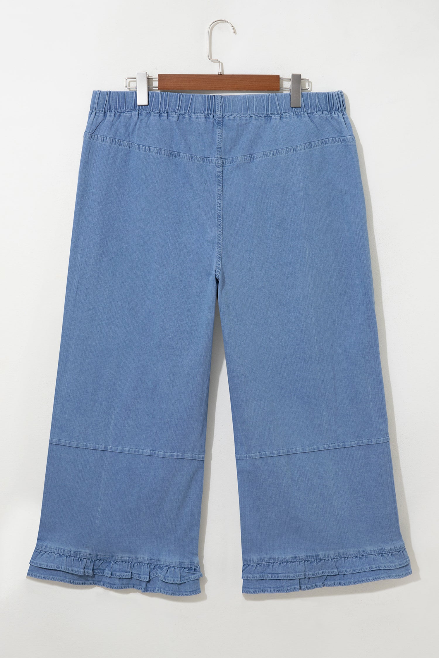 Light blue plus size wide leg jeans with ruffle hem and relaxed fit, women’s boutique denim style