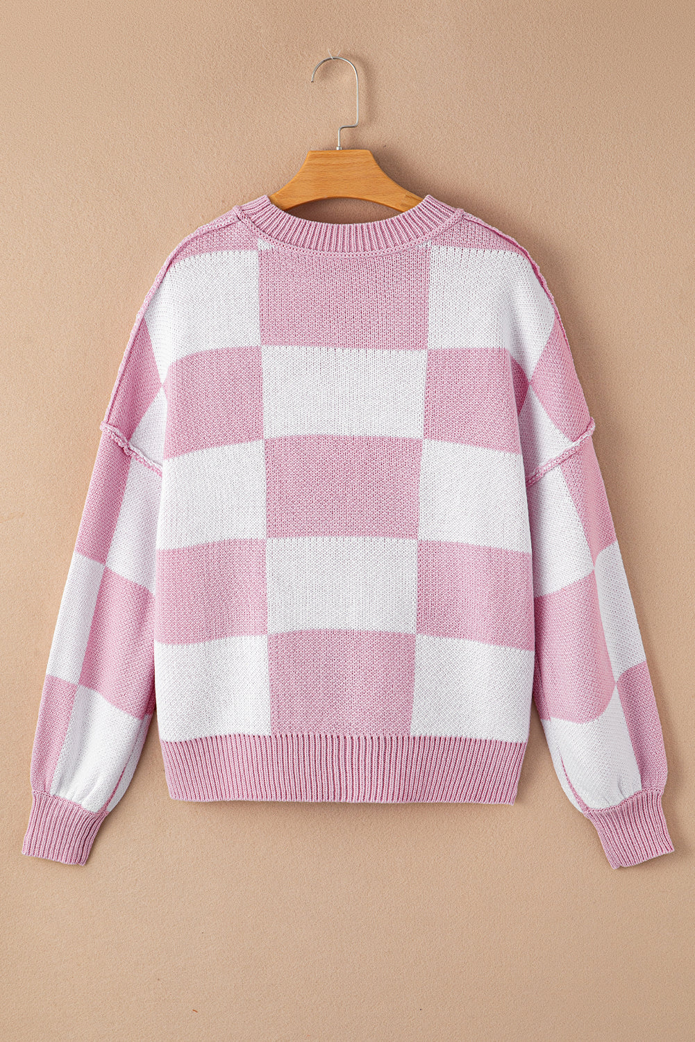 Pink checkered exposed seam drop shoulder sweater with checkered knit, exposed seam details and relaxed drop shoulders, women’s boutique fashion