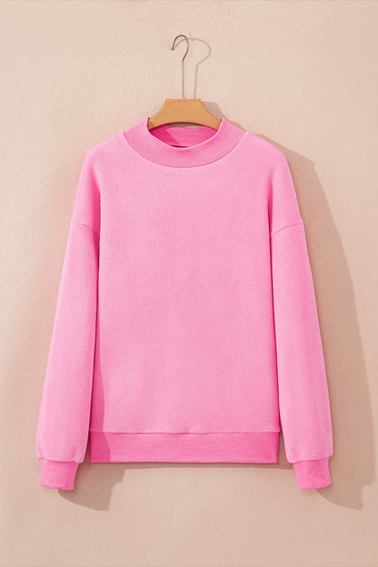 Bright pink plus size reversible mock neck sweatshirt with exposed seams and relaxed drop shoulders, boutique casual top