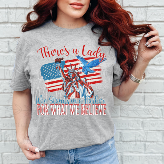 There's A Lady Who Stands In A Harbor For What We Believe Tshirt