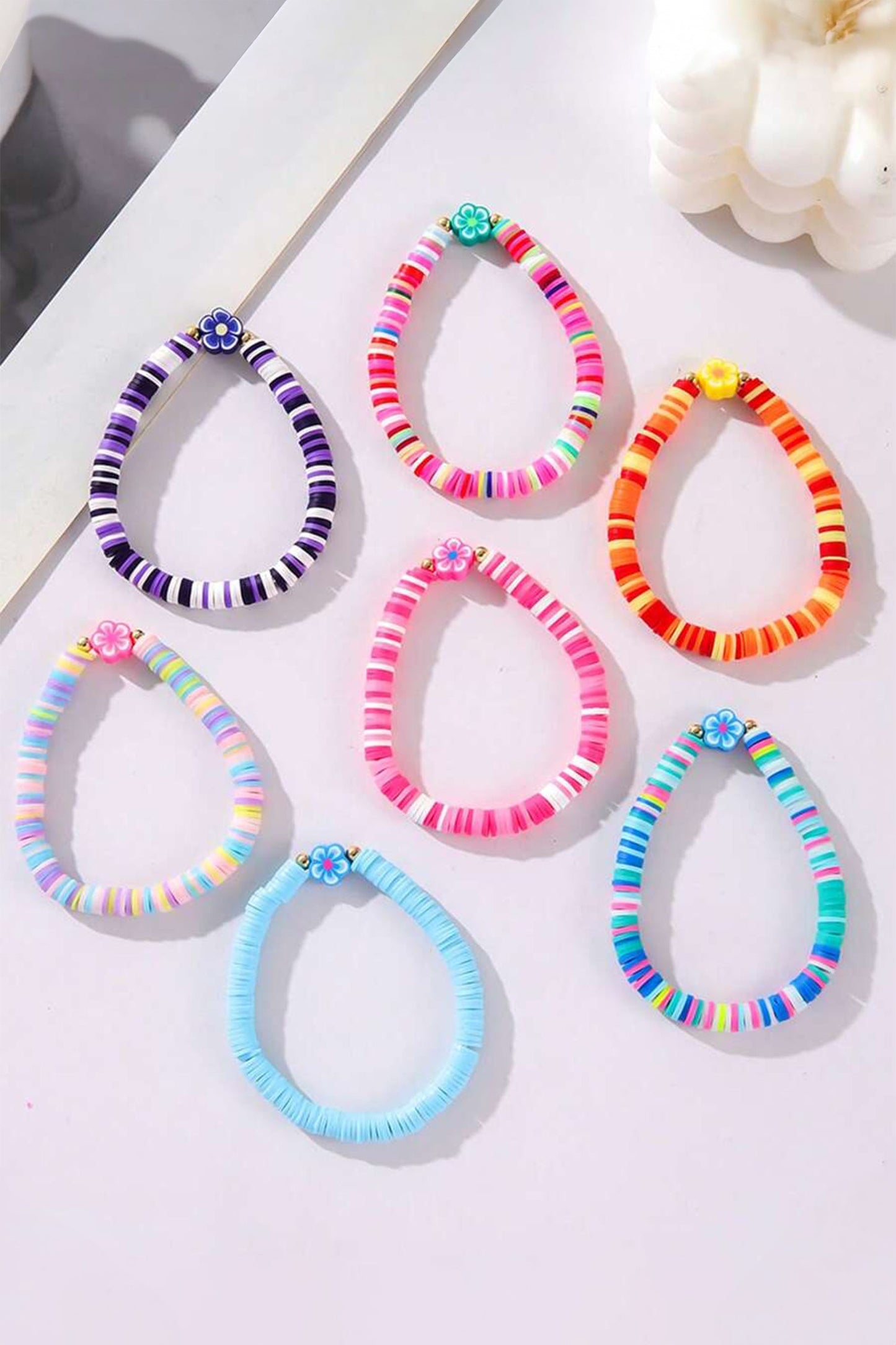 Colorful beaded bracelets on a light surface