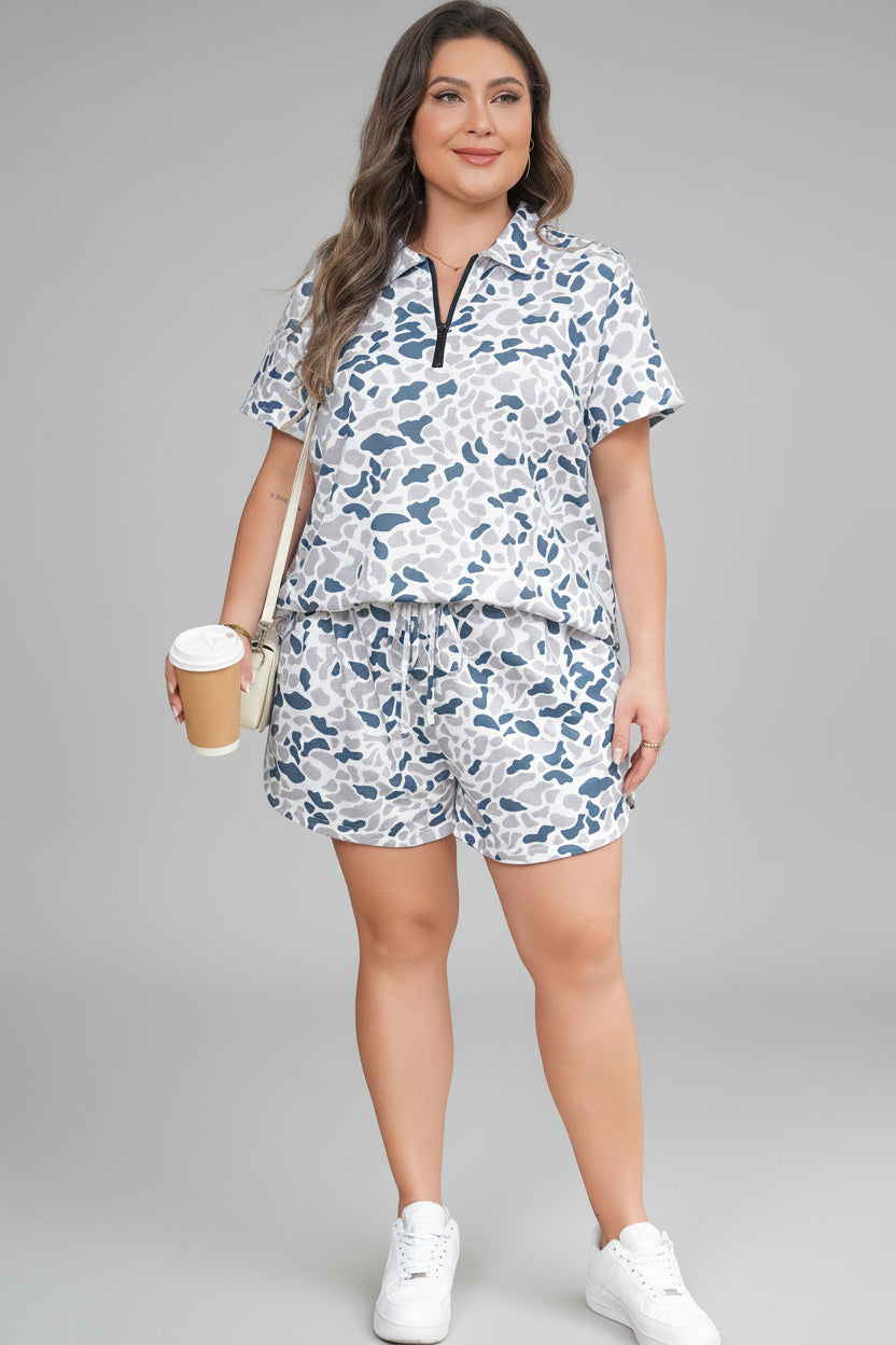 Woman in a floral outfit holding a coffee cup, standing in front of a door with a wreath.
