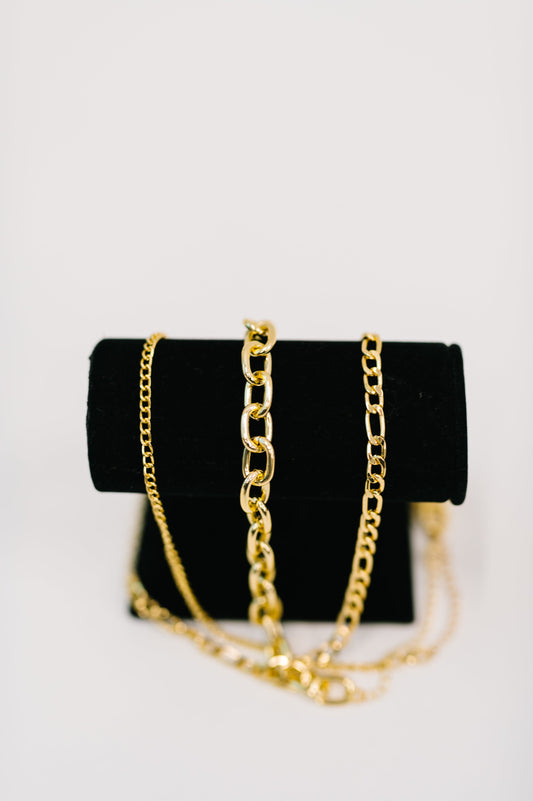 Black handbag with gold chain on a white background