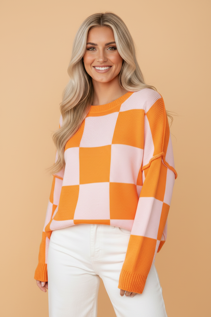 Grapefruit Orange checkered exposed seam drop shoulder sweater with checkered knit, exposed seam details and relaxed drop shoulders, women’s boutique fashion