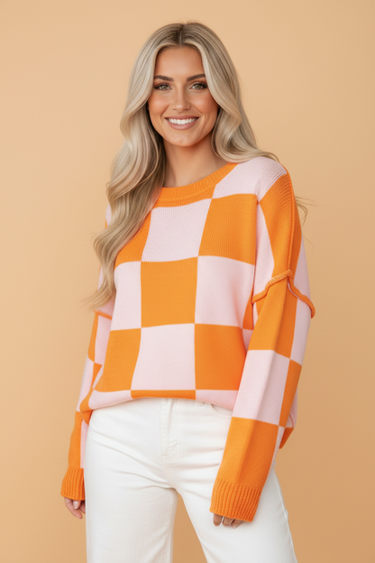 Grapefruit Orange checkered exposed seam drop shoulder sweater with checkered knit, exposed seam details and relaxed drop shoulders, women’s boutique fashion