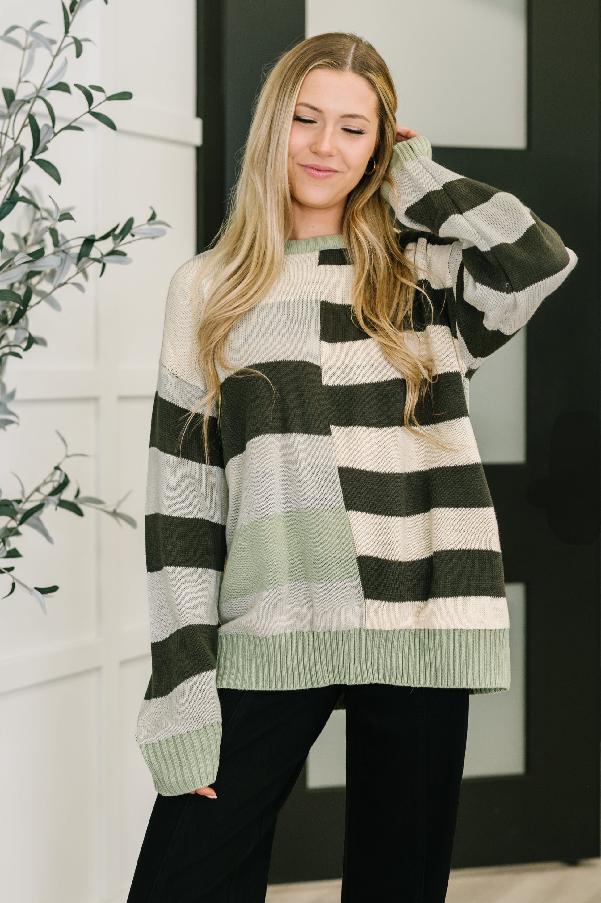 Woman wearing a striped sweater in a home setting