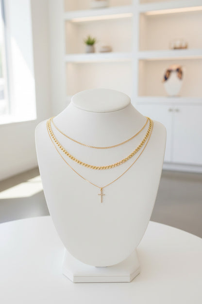 Gold necklaces with a cross pendant on a white background