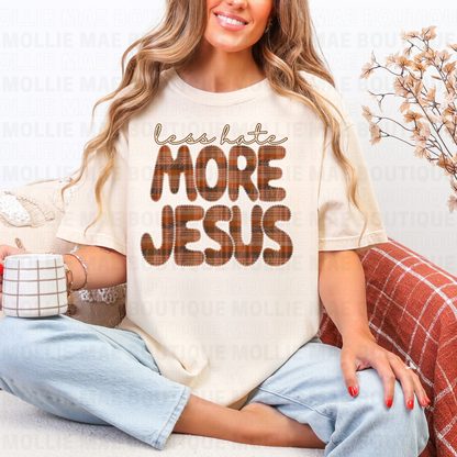 Woman wearing Less Hate More Jesus graphic tee on Comfort Colors Ivory.