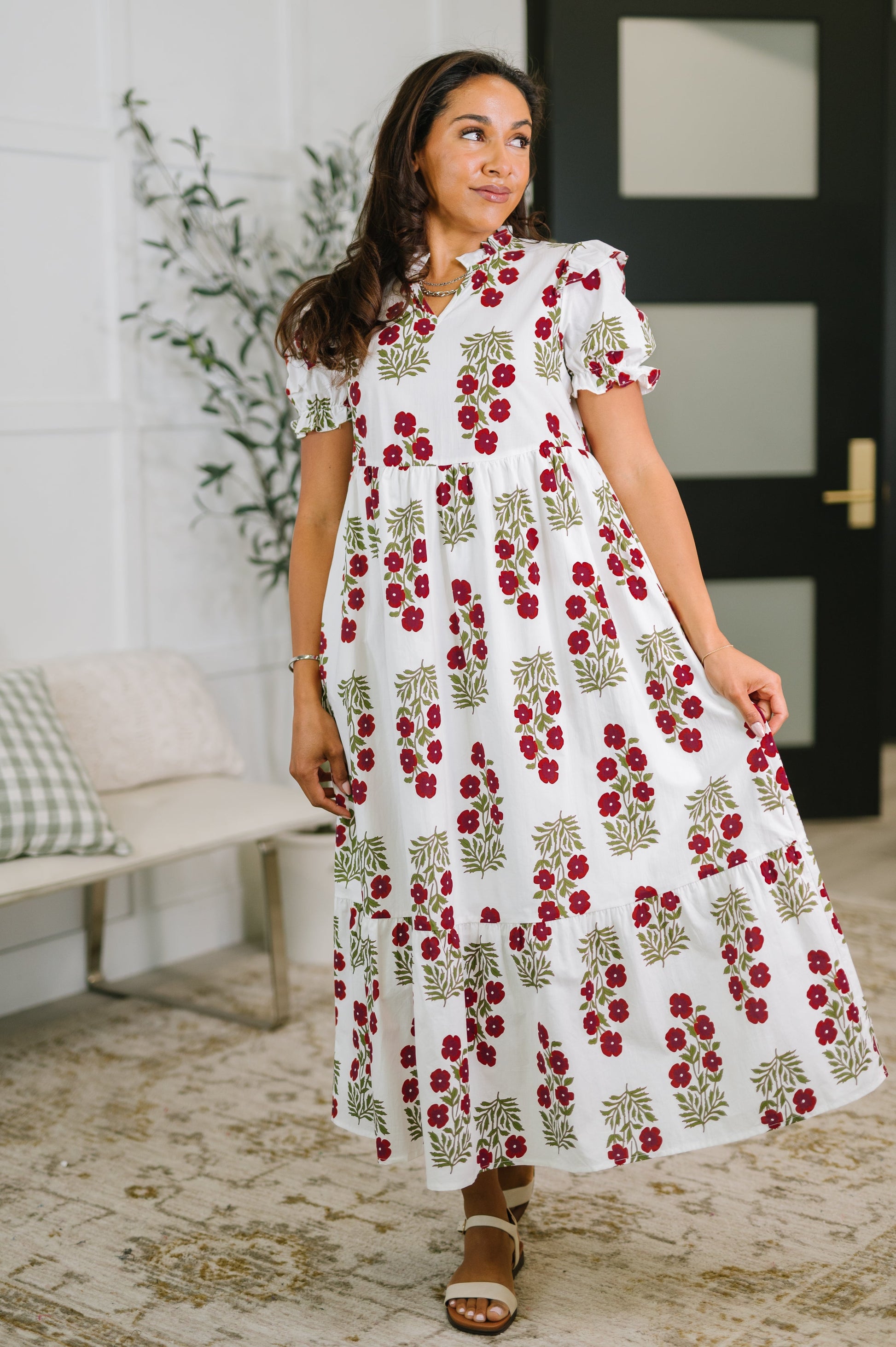 Woman wearing a floral dress in a home setting