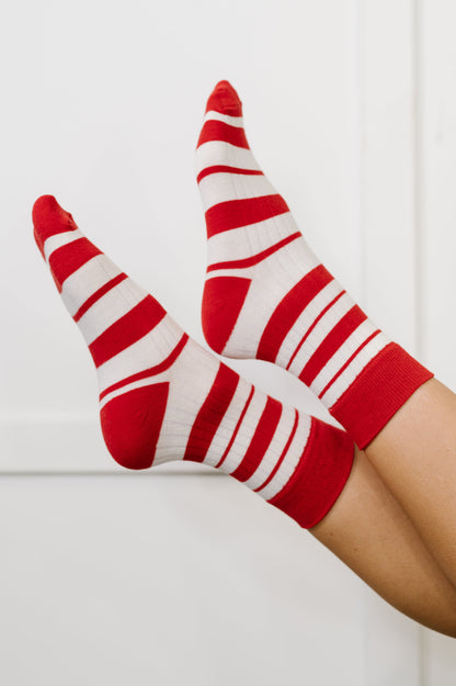Red and white striped socks on a white background