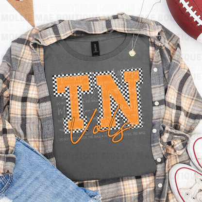 Flatlay of Tennessee Vols Checkered Graphic Tee styled with flannel and sneakers