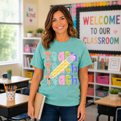 Teacher wearing colorful Teach Teach Teach Pencil Graphic Tee on Comfort Colors Chalky Mint in a bright classroom setting.