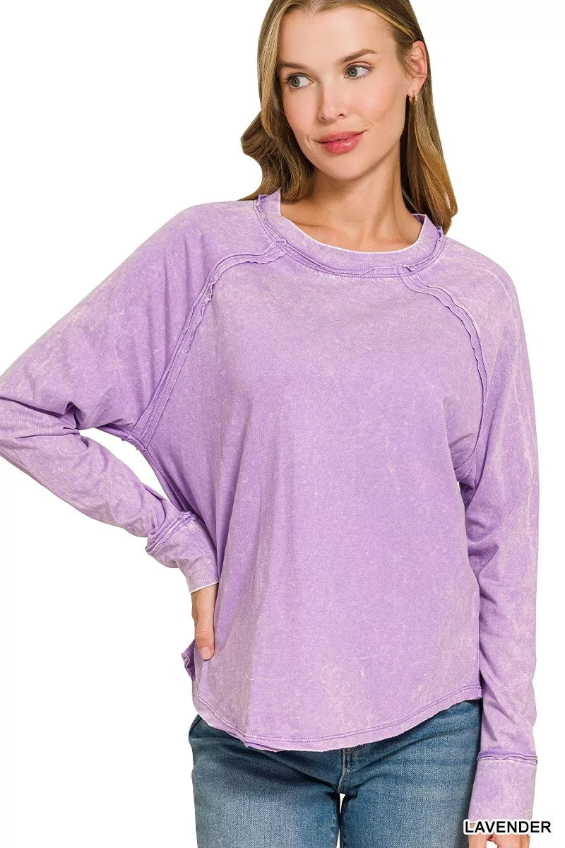 Lavender washed cotton long sleeve top with crew neck, exposed seams, and raw hem