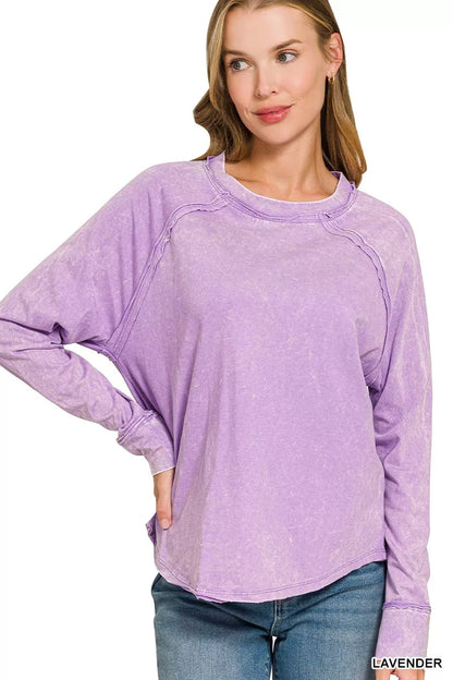 Lavender washed cotton long sleeve top with crew neck, exposed seams, and raw hem