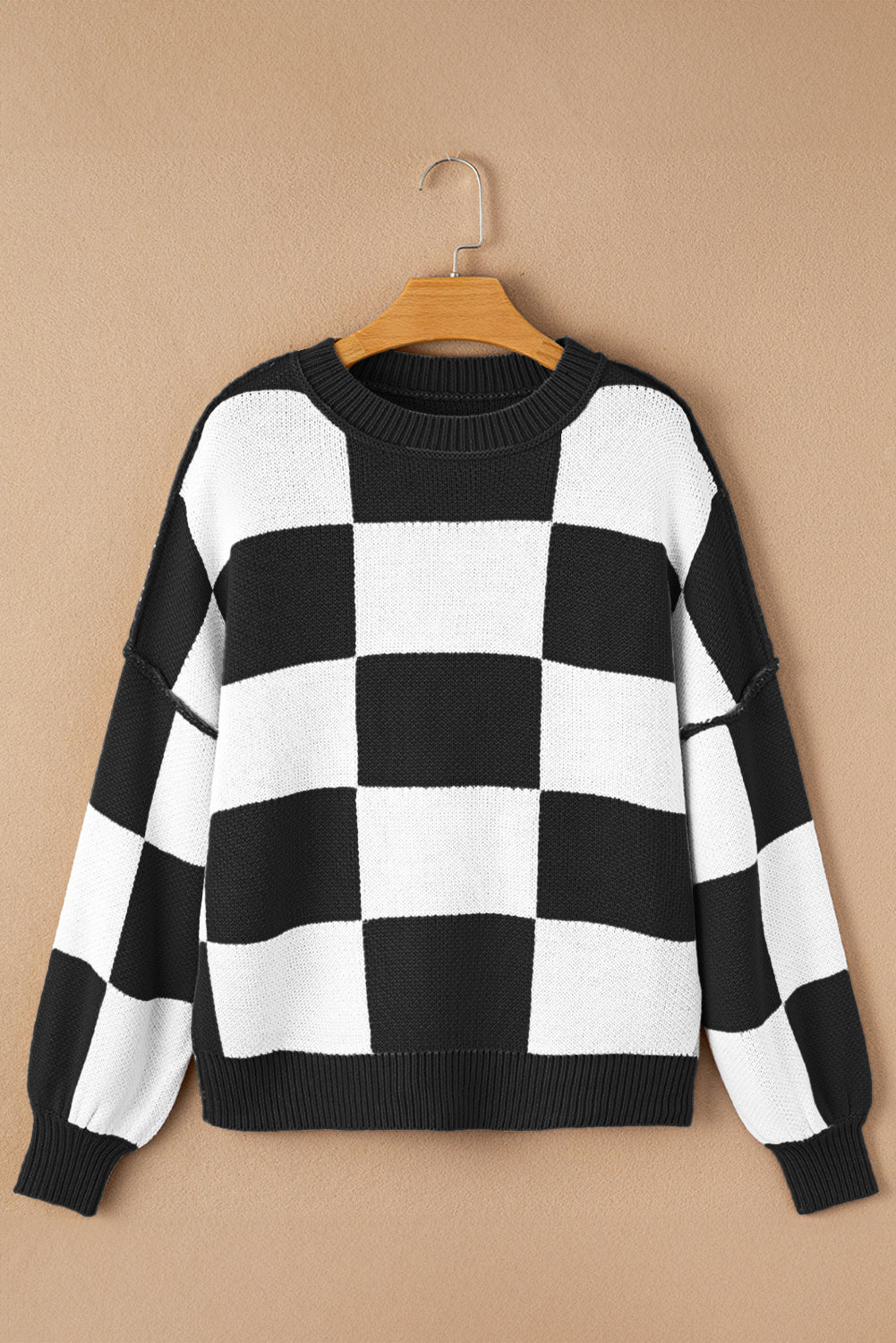 Black checkered exposed seam drop shoulder sweater with checkered knit, exposed seam details and relaxed drop shoulders, women’s boutique fashion