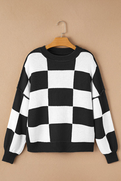 Black checkered exposed seam drop shoulder sweater with checkered knit, exposed seam details and relaxed drop shoulders, women’s boutique fashion