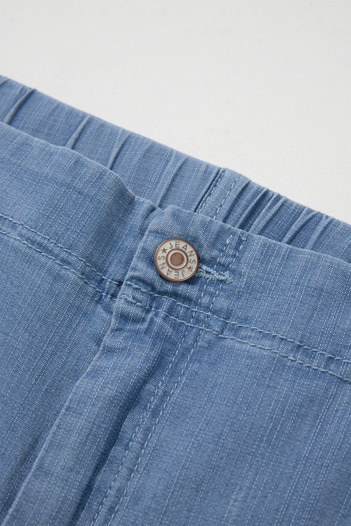 Light blue plus size wide leg jeans with ruffle hem and relaxed fit, women’s boutique denim style