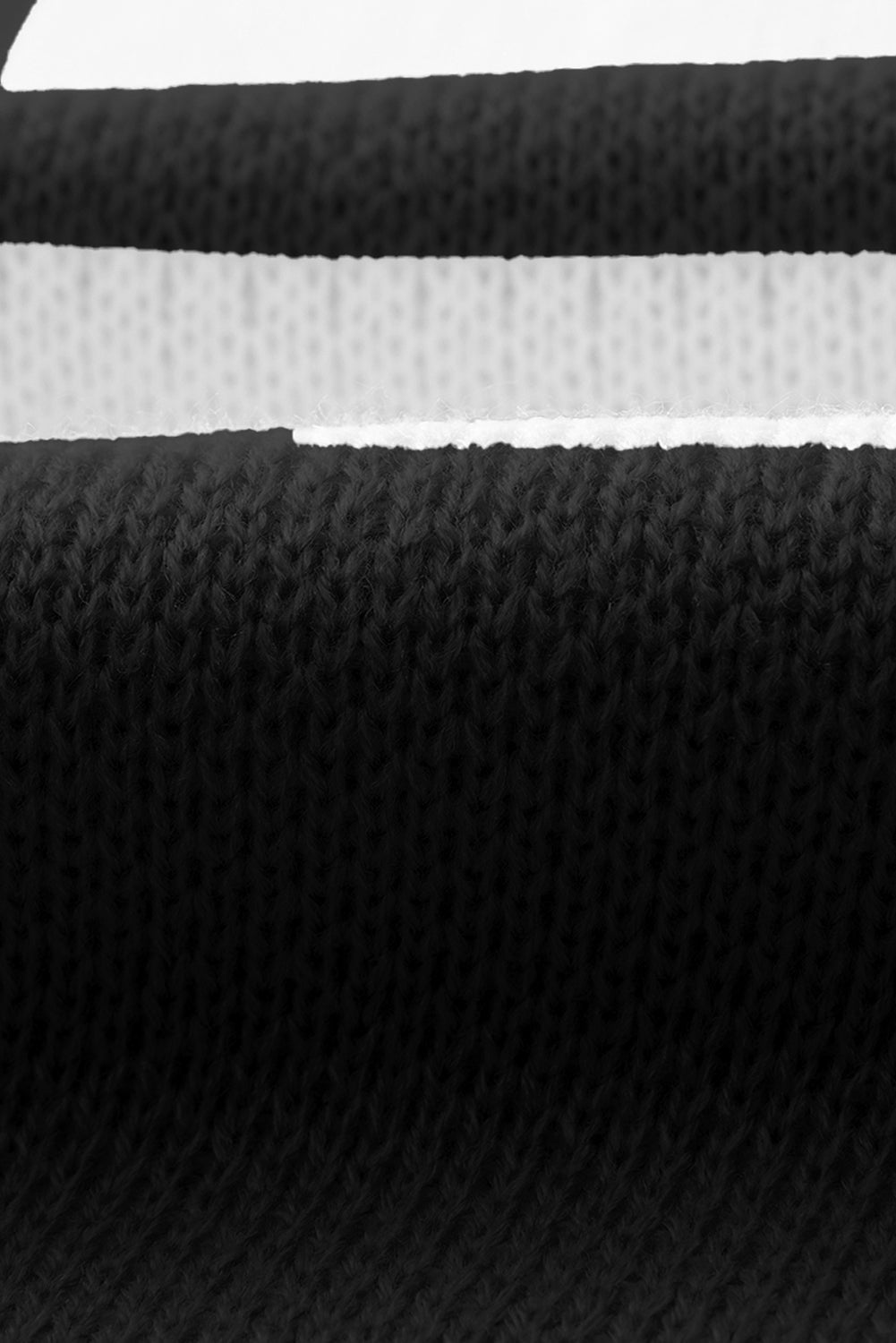 Black checkered exposed seam drop shoulder sweater with checkered knit, exposed seam details and relaxed drop shoulders, women’s boutique fashion