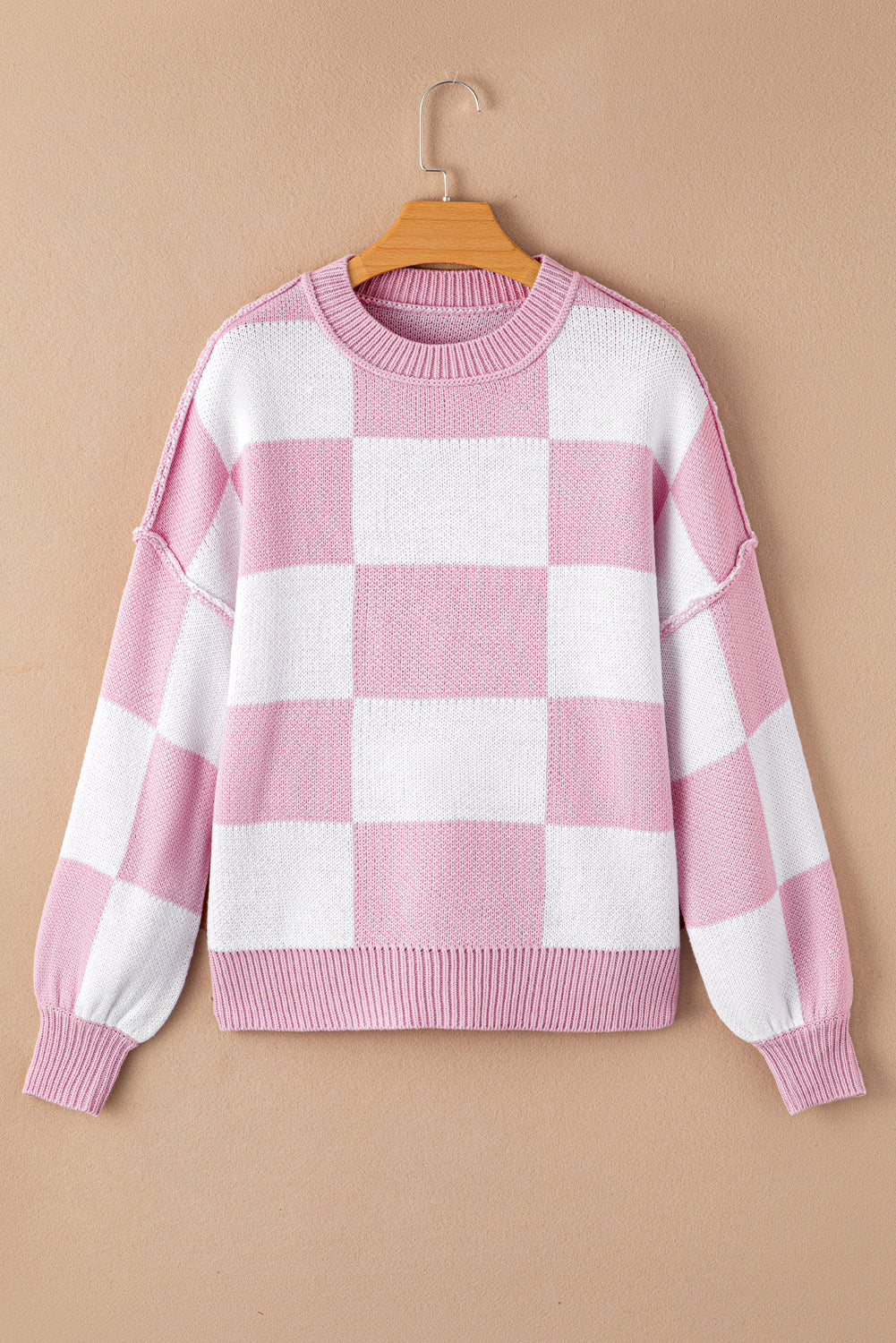 Pink checkered exposed seam drop shoulder sweater with checkered knit, exposed seam details and relaxed drop shoulders, women’s boutique fashion