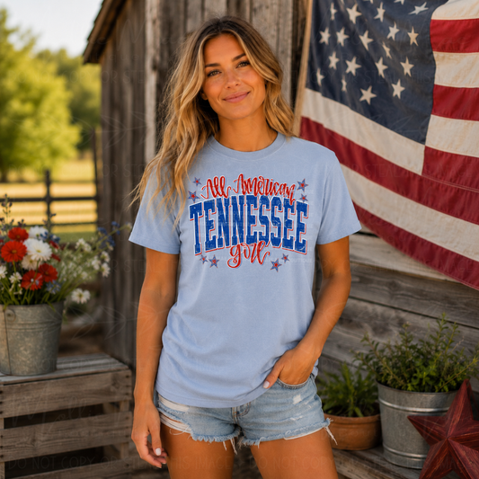 Comfort Colors Hydrangea graphic tee featuring All American Tennessee Girly patriotic design with red, white, and blue lettering and star accents.
